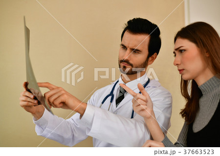 Health Concepts. Doctor and patient viewing x-ray film. The doct 37663523