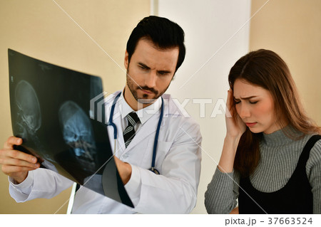 Health Concepts. Doctor and patient viewing x-ray film. The doct Health Concepts. Doctor and patient viewing x-ray film. The doct 37663524