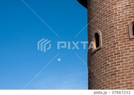 red brick block round tower with two round windows 37667252