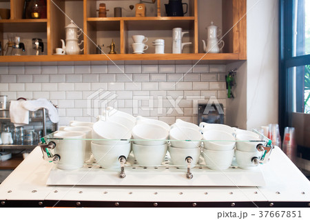 Coffee cups on counter in modern cafe, Interior  Coffee cups on counter in modern cafe, Interior  37667851