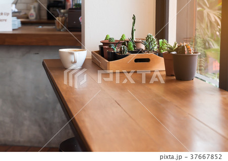 Wooden table near glass window in cafe Wooden table near glass window in cafe 37667852