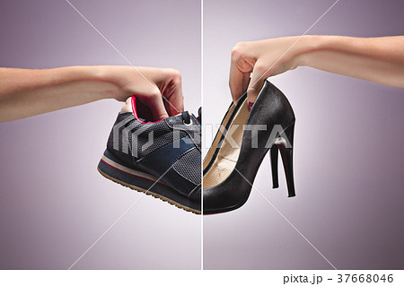Hand Holding An Old Dirty Sneaker Shoe Hand Holding An Old Dirty Sneaker Shoe 37668046