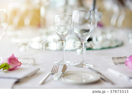 Beautiful table setting with crockery and flowers 37673315