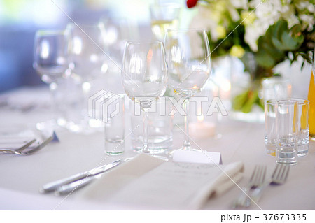 Beautiful table setting with crockery and flowers 37673335