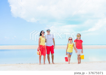 Family of four on beach vacation having a lot of Family of four on beach vacation having a lot of 37675071