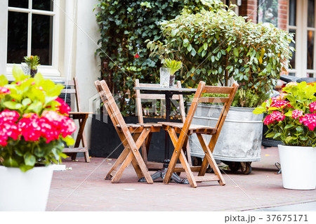 Outdoor cafe on a street of typical greek Outdoor cafe on a street of typical greek 37675171