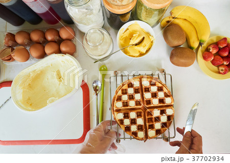 Making waffles for breakfast 37702934