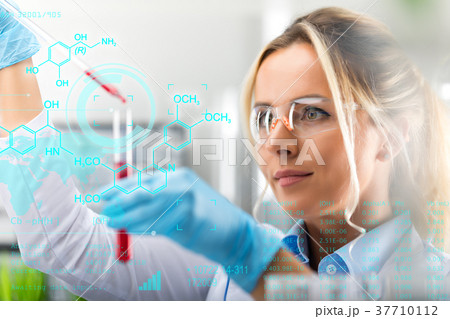 Young attractive female scientist researching in the laboratory Young attractive female scientist researching in the laboratory 37710112