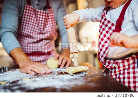 Young family making cookies at home. Young family making cookies at home. 37710780