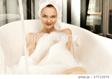 Young beautiful red-haired woman takes bubble bath 37712074