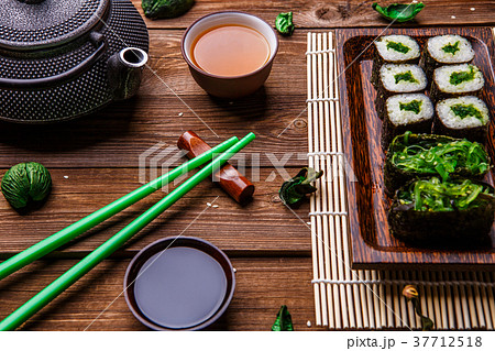 Wooden surface with rolls, chopsticks 37712518
