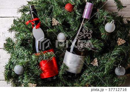 Photo of spruce branches with two bottles of wine 37712716