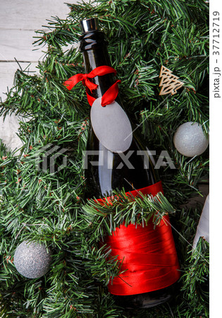 Photo of spruce branches with bottle of wine 37712719