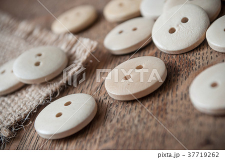 wooden sewing buttons on wooden table background 37719262