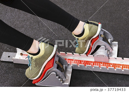 Sprinter in spikes in the blocks indoor 37719433