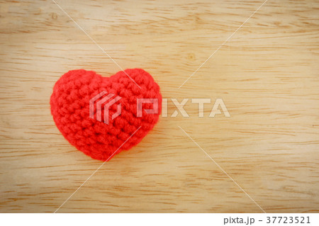 Red heart knit with yarn on wooden floor 37723521