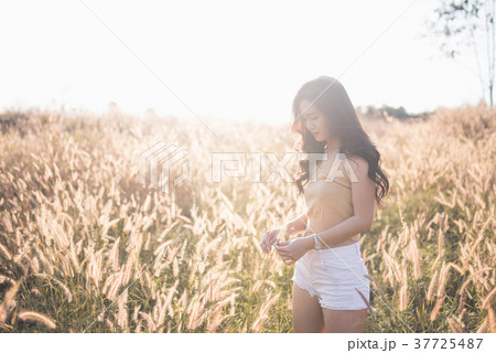Portrait Asia girl in the sunset on the field 37725487