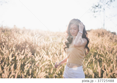 Portrait Asia girl in the sunset on the field Portrait Asia girl in the sunset on the field 37725488
