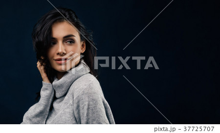 Young smiling woman wearing gray sweater Young smiling woman wearing gray sweater 37725707