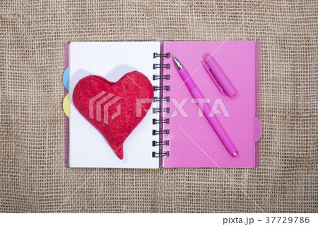 Notebook with ballpoint pen and red heart 37729786
