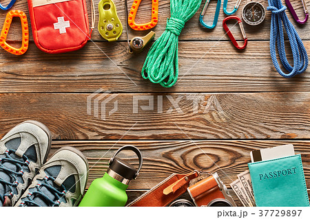 Travel items for hiking over wooden background 37729897