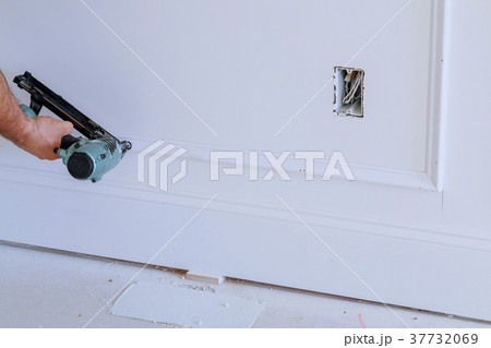 home owner repairing frame molding with nail gun, home owner repairing frame molding with nail gun, 37732069