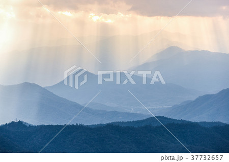 Sunbeam from cloudy sky to blue mountains range Sunbeam from cloudy sky to blue mountains range 37732657