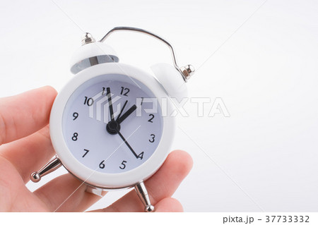 Child holding an alarm clock 37733332