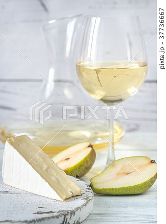 Glass of white wine with cheese and pears Glass of white wine with cheese and pears 37736667