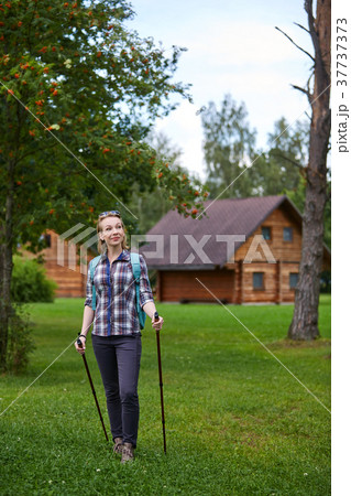 young woman with nordic walk pols young woman with nordic walk pols 37737373
