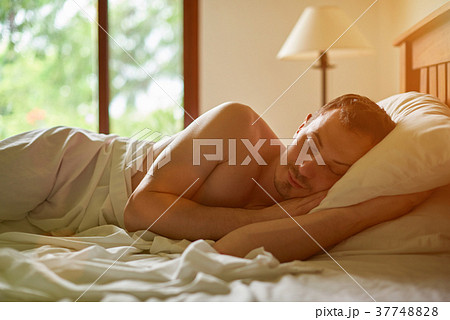 One man sleeping in bed One man sleeping in bed 37748828