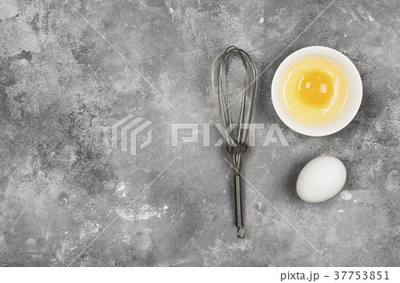 Eggs and whisk for whipping on a gray background Eggs and whisk for whipping on a gray background 37753851