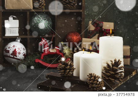 Burning candles and Christmas attributes Burning candles and Christmas attributes 37754978