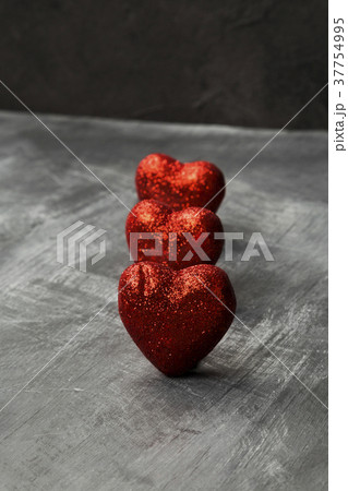 Red hearts on a dark background Red hearts on a dark background 37754995