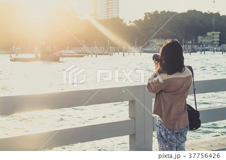 women photographer take a photo of sea view women photographer take a photo of sea view 37756426
