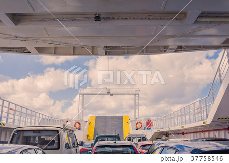 Bow ramp of and cars inside of ferry.  37758546