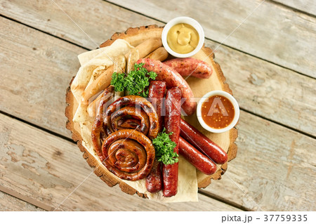 Top view of sausage assortment dish. 37759335