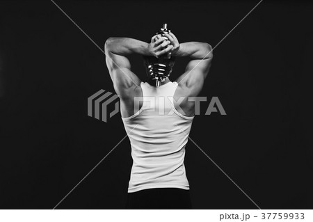 Strong athletic man with dumbbell showes muscular 37759933