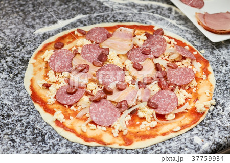 Sausage slices on pizza basis. 37759934