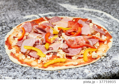 Pizza with sausages, sliced pepper and tomatoes. 37759935