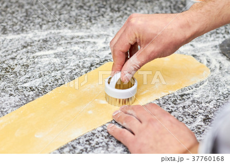 Chef using cutting dough metal form. 37760168