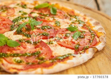 Close up tomato pizza with basil. Close up tomato pizza with basil. 37760378
