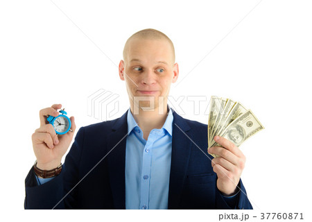 Confused Businessman with alarm clock and stack of 37760871