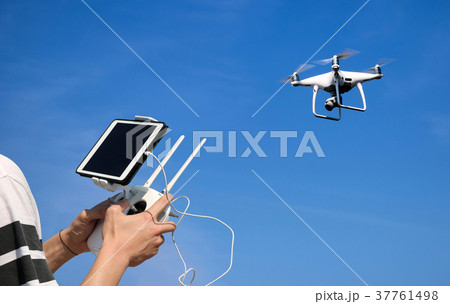 Hands control a drone camera while flying by phone Hands control a drone camera while flying by phone 37761498