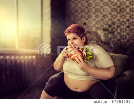 Overweight woman eats sandwich, bulimic 37761582