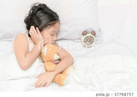 cute girl sleep and hug trddy bear doll 37768757