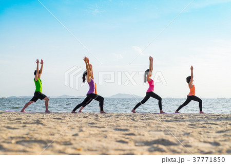 Yoga class at sea beach in sunset time 37771850