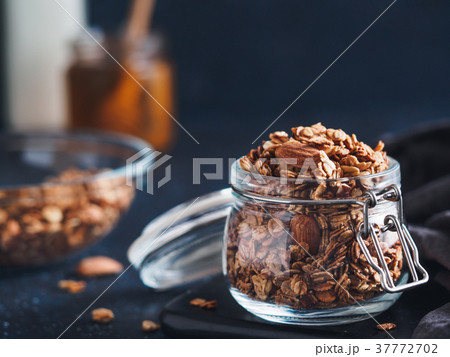 Homemade granola in glass jar on dark table 37772702