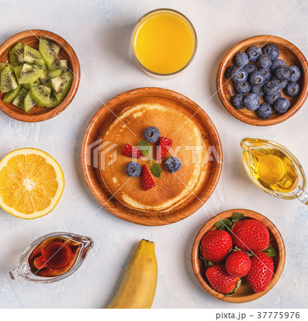 Pancakes with fruit, honey, maple syrup. Pancakes with fruit, honey, maple syrup. 37775976