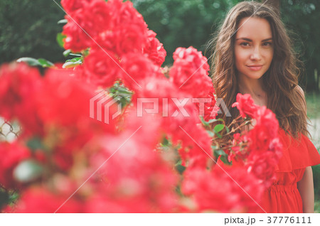 Beautiful young woman surrounded by flowers 37776111